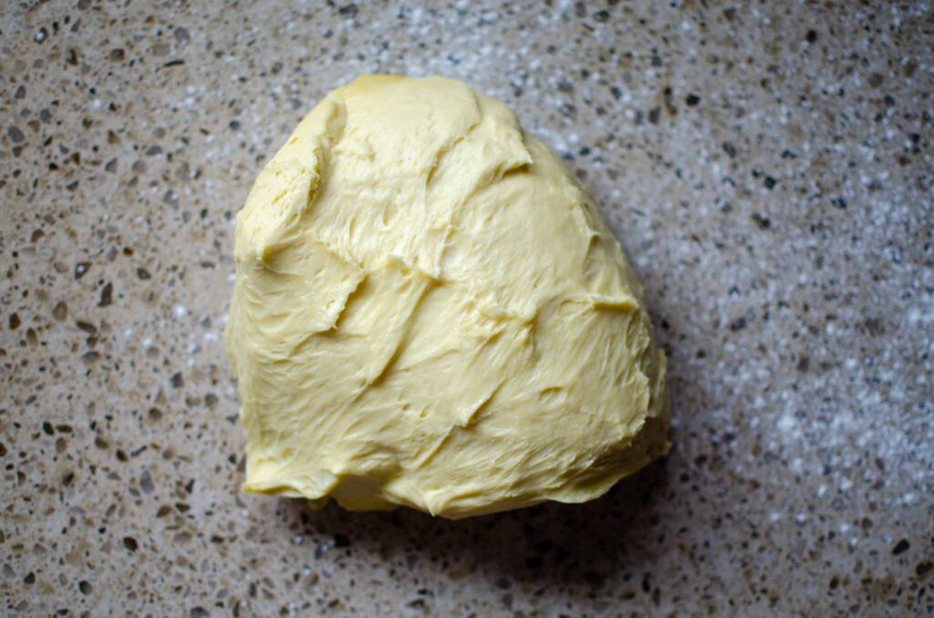 sourdough cinnamon roll dough on lightly floured work surface