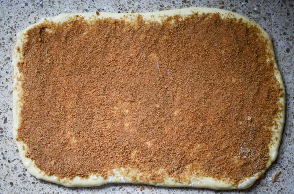 cinnamon sugar mixture spread over softened butter on cinnamon roll dough