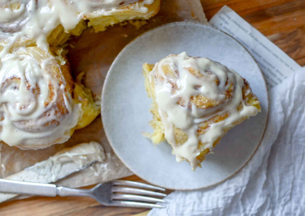 a fluffy sourdough cinnamon roll on a plate 