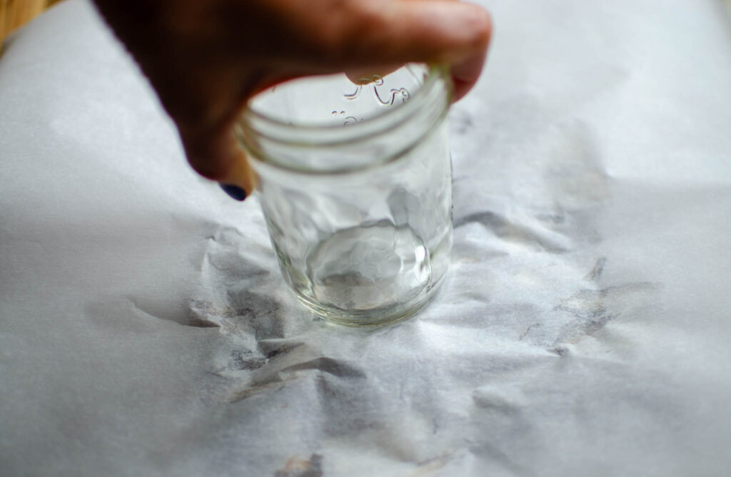 flattening the dates with a mason jar between pieces of parchment paper