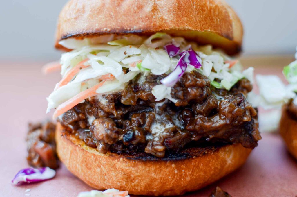 leftover beef brisket sandwich on bun with coleslaw topping