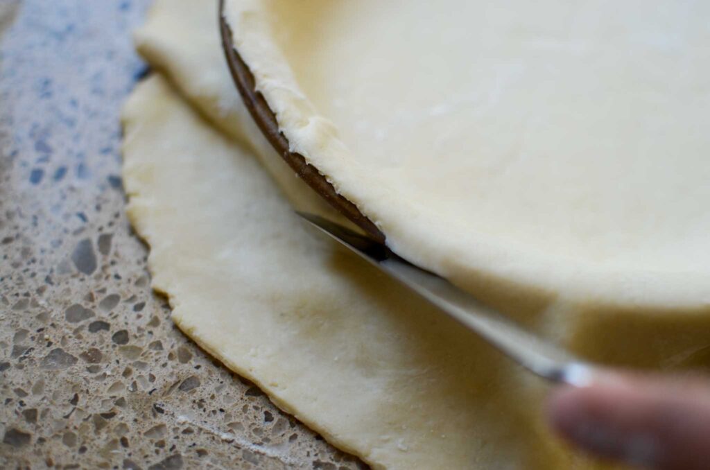 trimming edge of pie dough