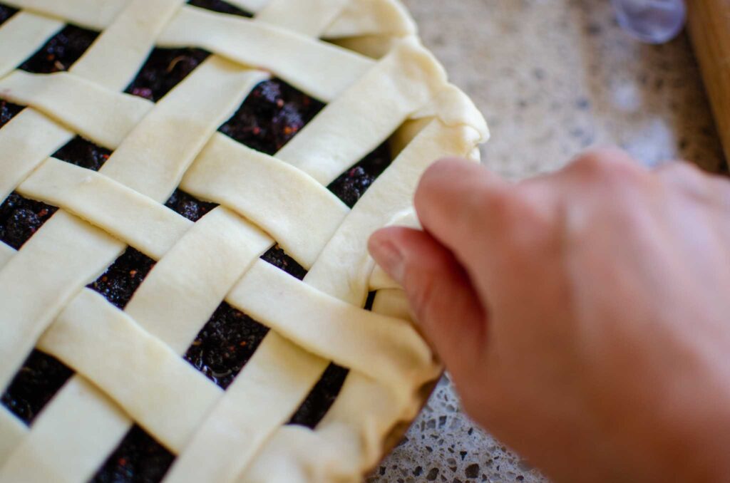 crimping the edges of a mulberry pie