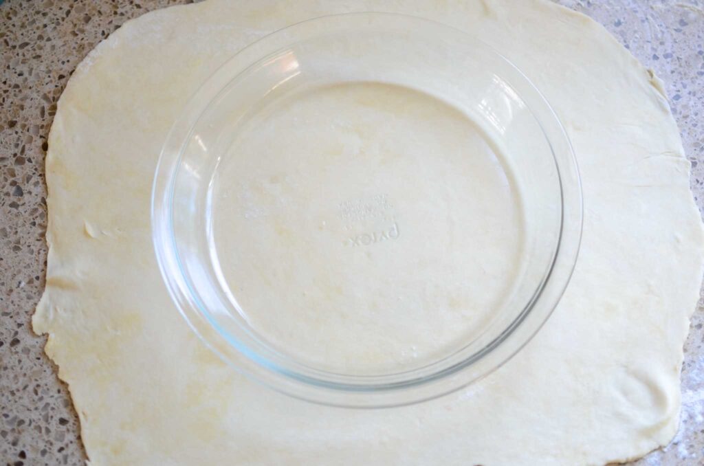 glass pie plate on rolled out sourdough pie crust