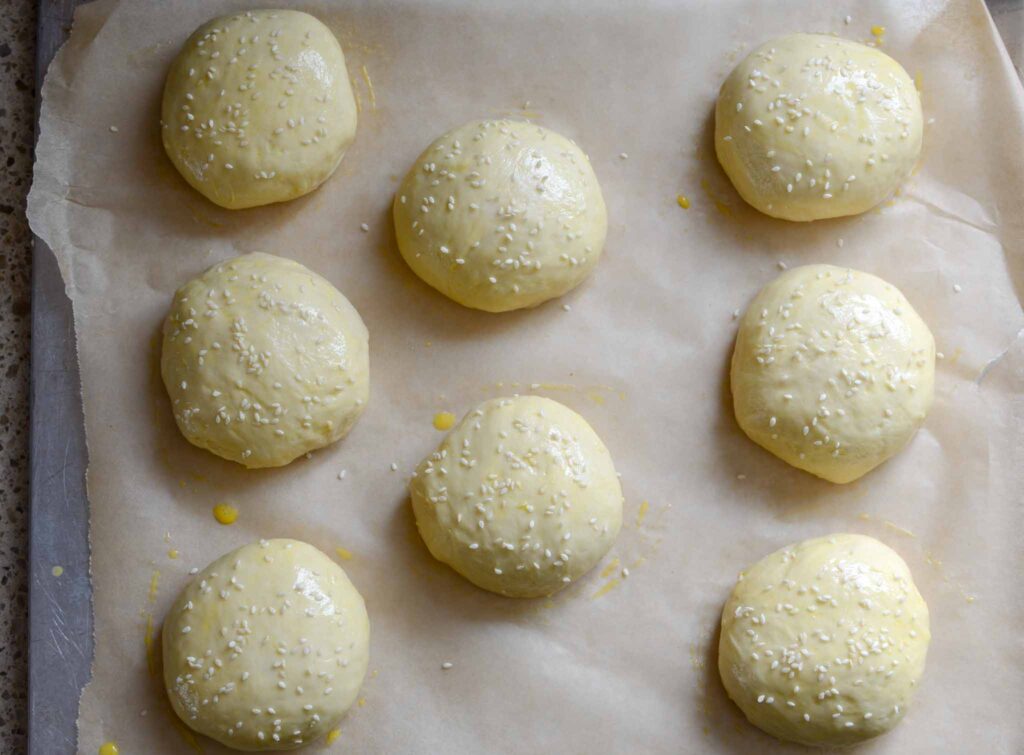 shaped dough balls on baking sheet after letting rise