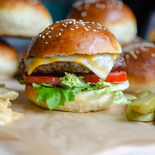 homemade 1 hour hamburger buns with a burger, chips, and pickles