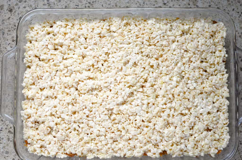 2nd layer of rice krispie treats in glass 9 x 13 pan