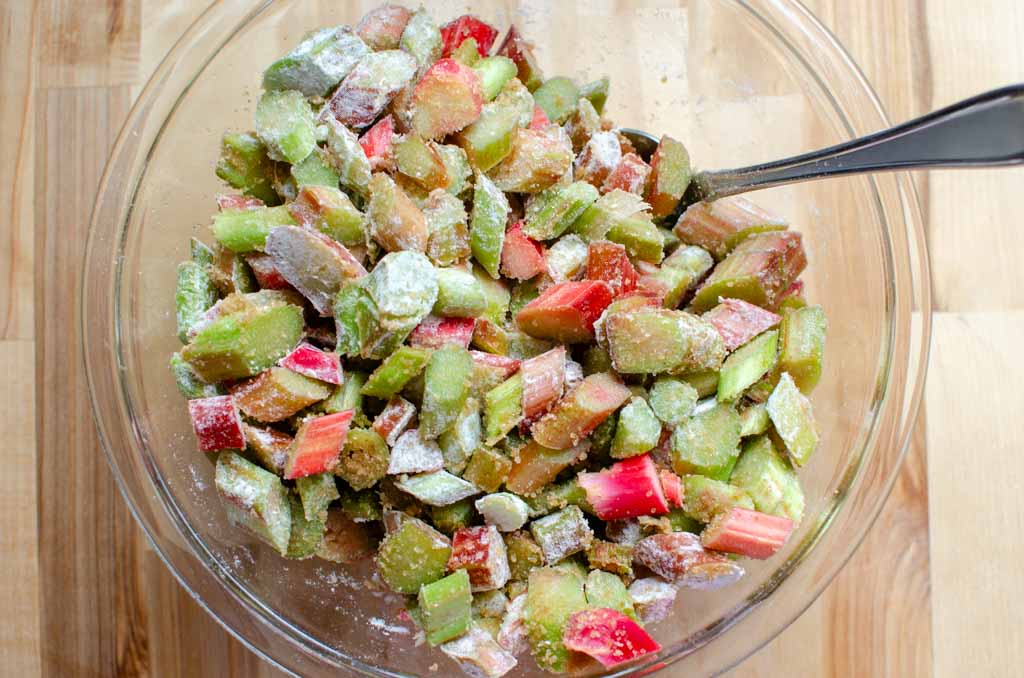 rhubarb mixture combined for rhubarb crisp in glass bowl