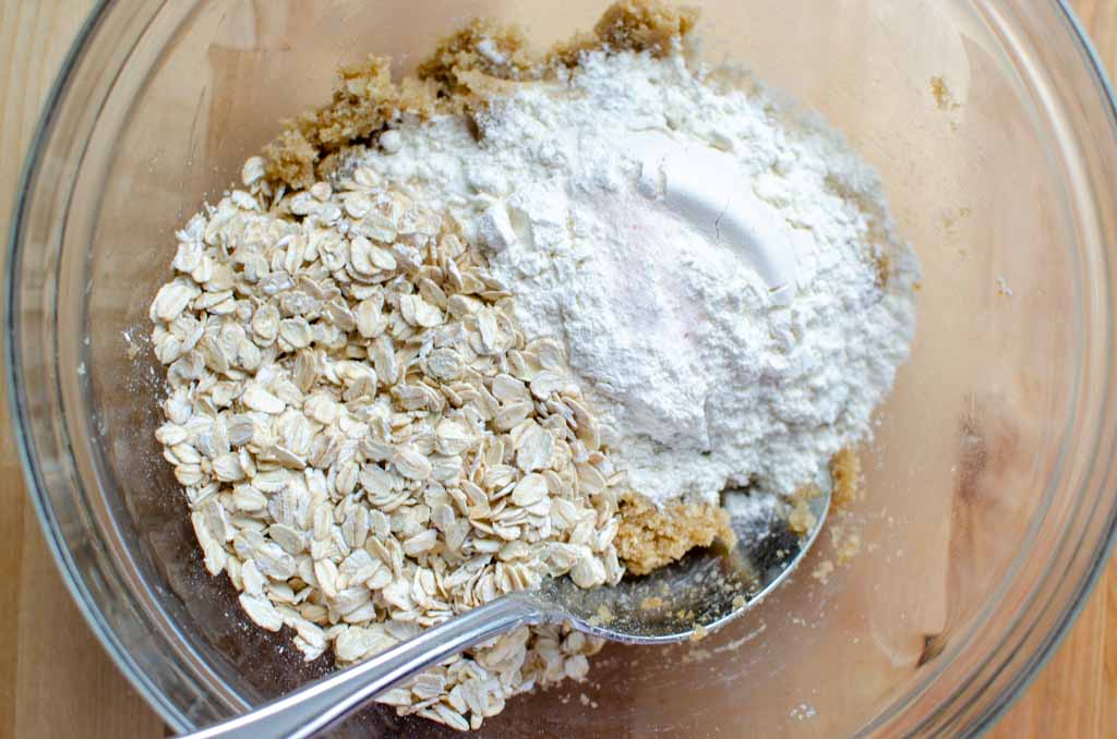 Dry ingredients added to butter mixture in glass bowl