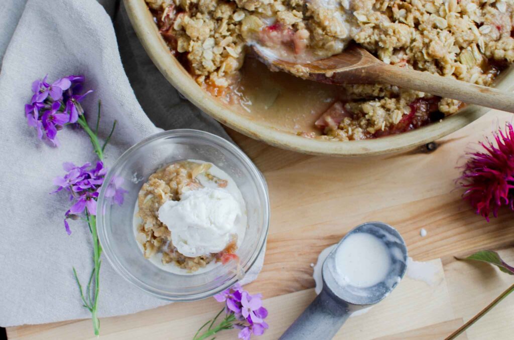 a serving of homemade rhubarb dessert and a scoop of vanilla ice cream