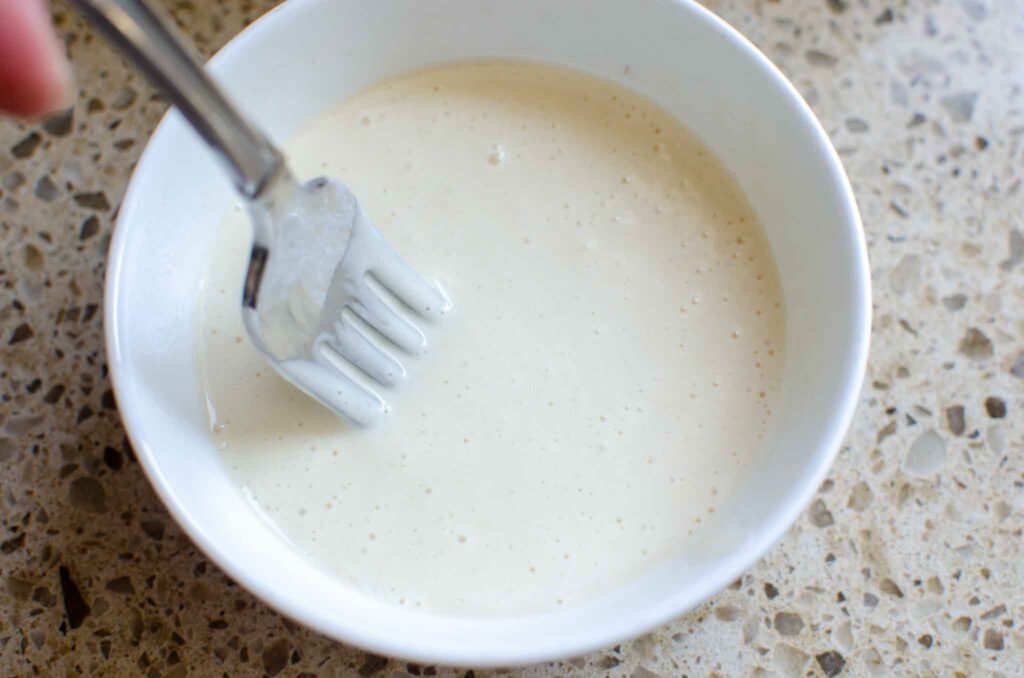 sourdough starter and vinegar in a small white bowl