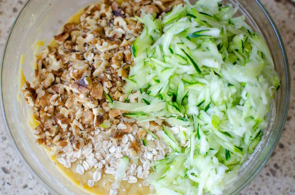 Adding grated zucchini, oatmeal and walnuts to batter