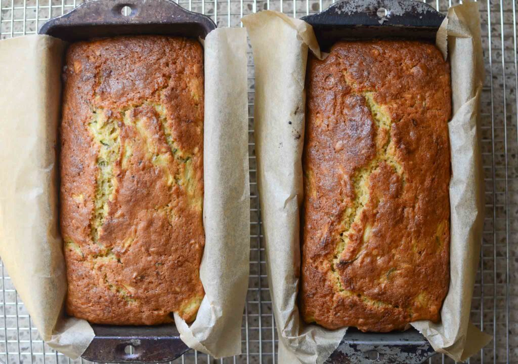 baked sourdough zucchini bread in parchment lined metal loaf pan