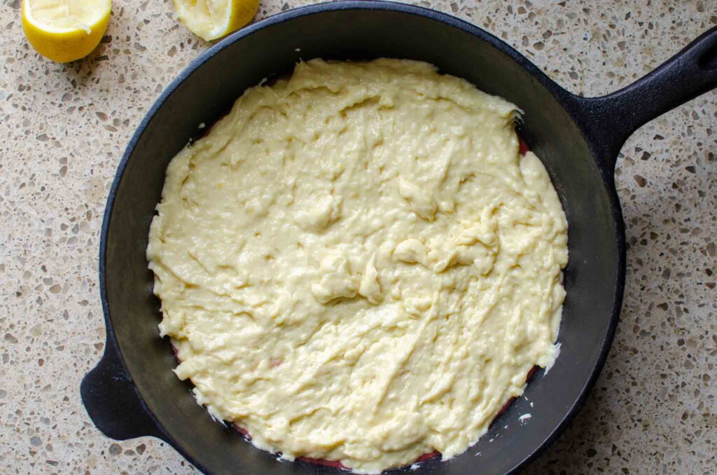 Rhubarb spoon cake batter in cast iron skillet