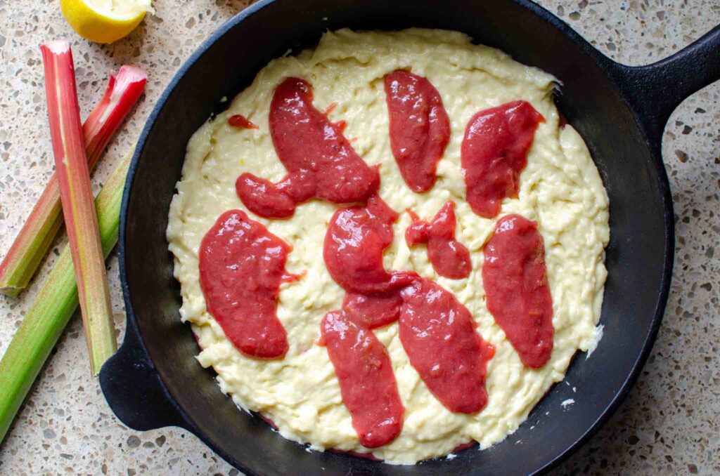 rhubarb compote dolloped over the rhubarb spoon cake batter