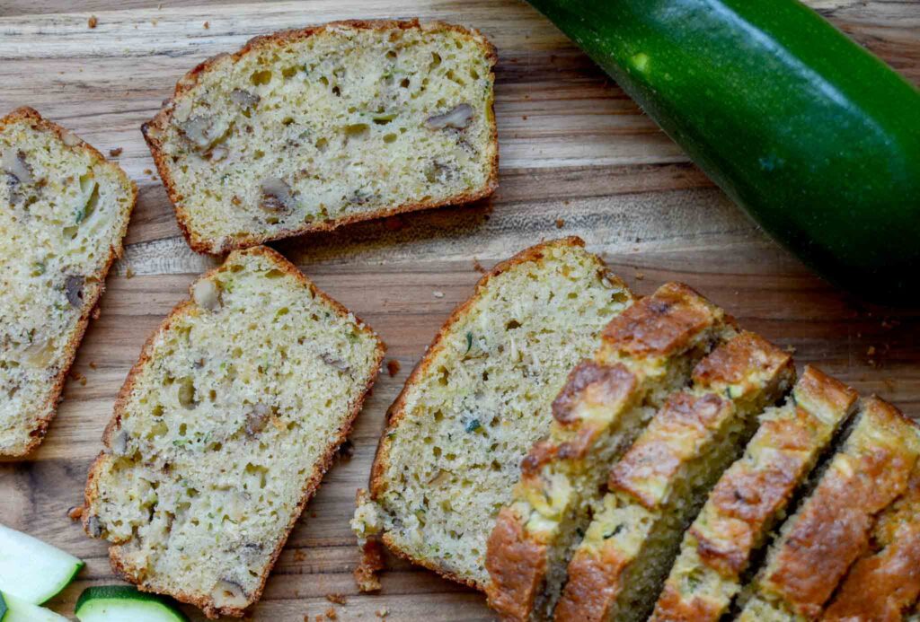 slices of sourdough zucchini bread on wooden cutting board 