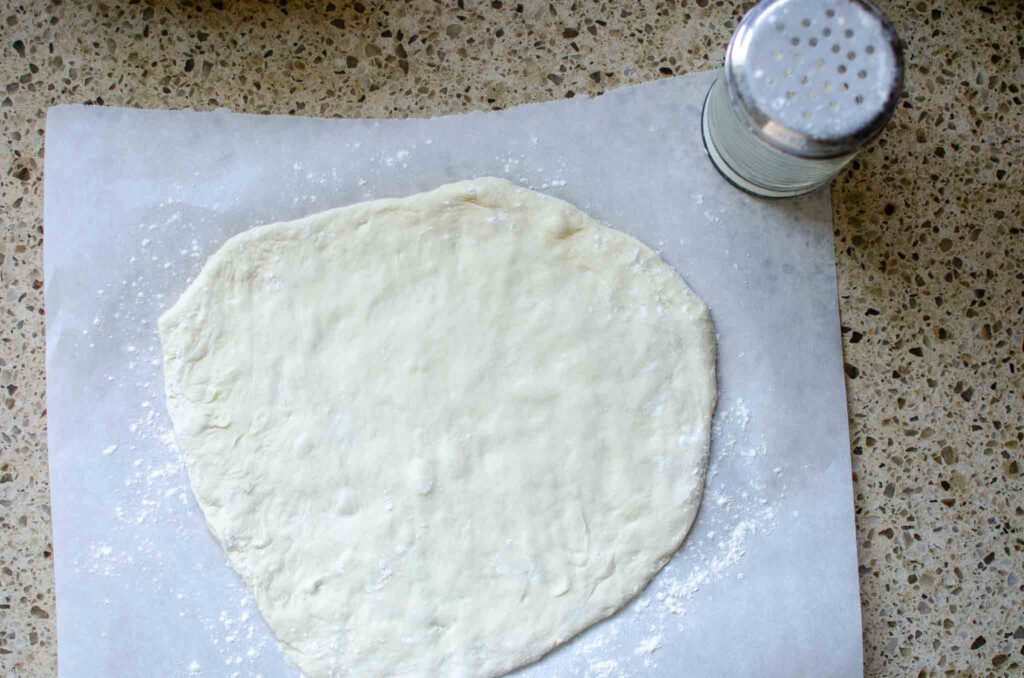 sourdough pizza dough on a piece of parchment paper