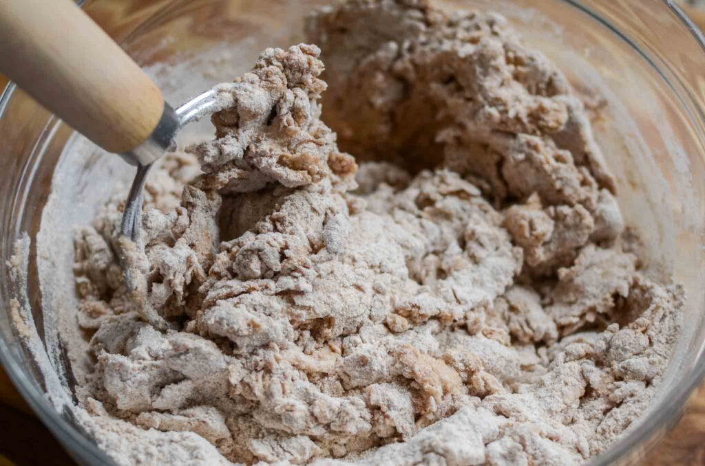 mixing 100% whole wheat sourdough bread dough with danish dough whisk