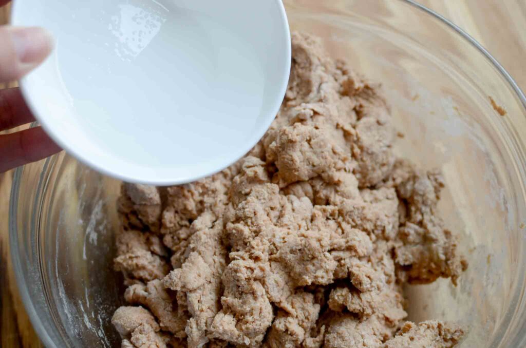 adding salt water to 100% whole wheat sourdough bread dough