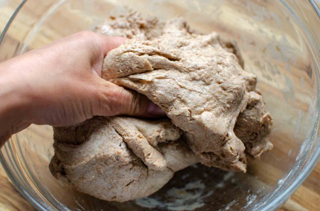 mixing salt water into dough with hand