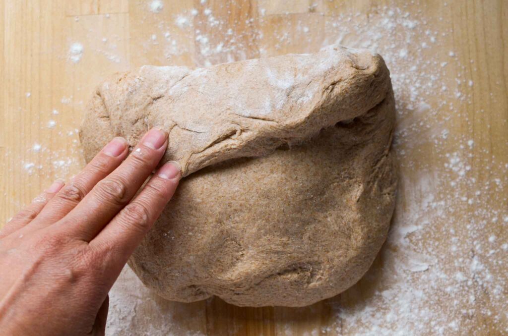 folding the top of the dough down to the middle 