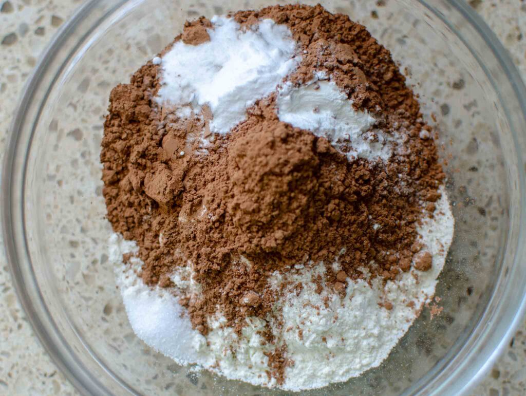 Dry ingredients in a glass bowl for sourdough chocolate zucchini bread