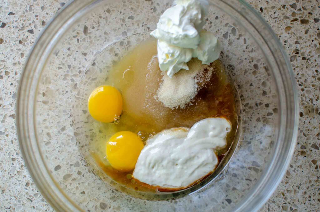 wet ingredients in a glass bowl for sourdough chocolate zucchini bread