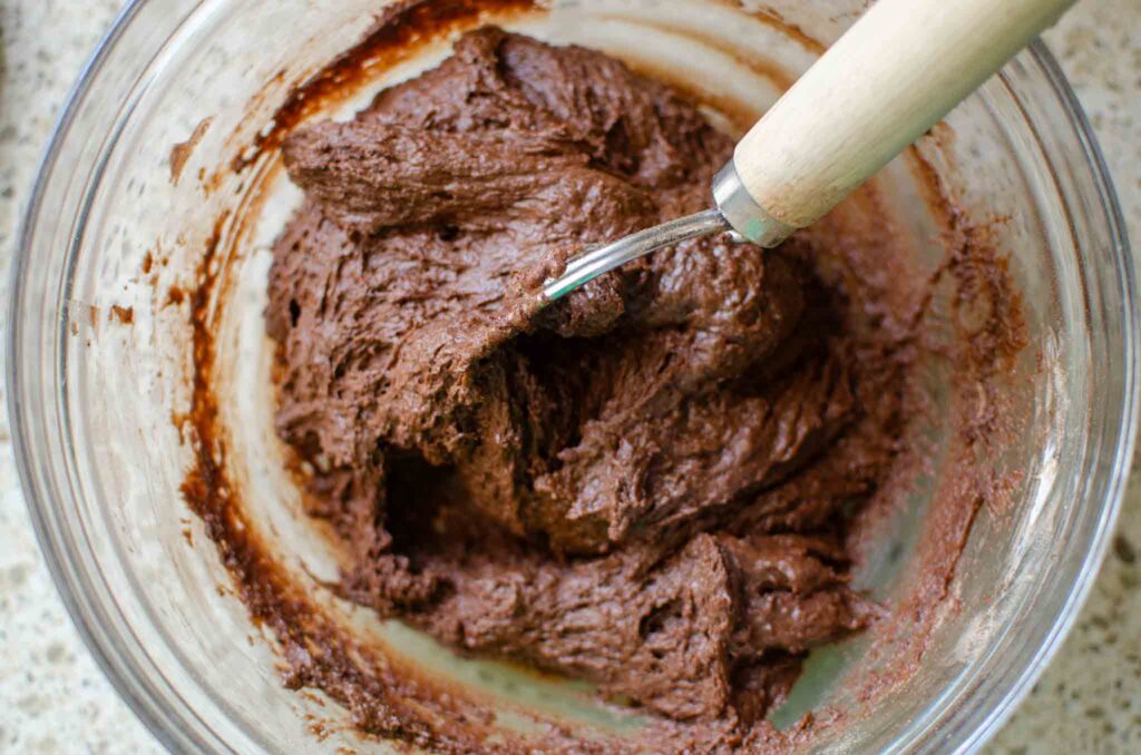 mixed sourdough chocolate zucchini bread batter in a glass bowl