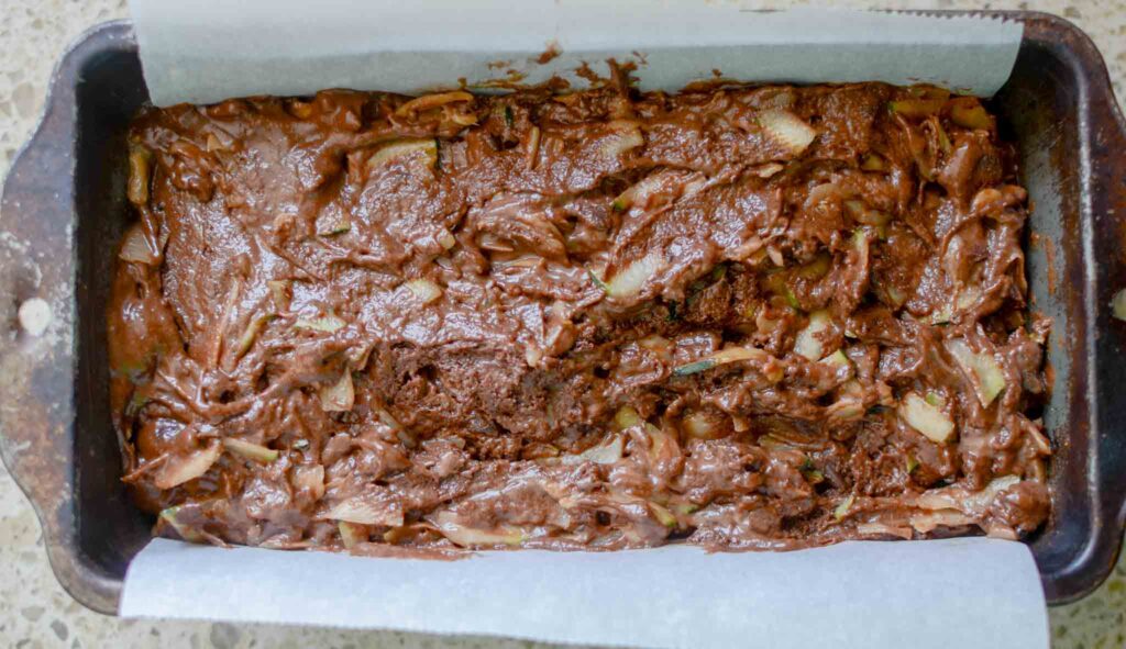 sourdough chocolate zucchini bread batter in loaf pan