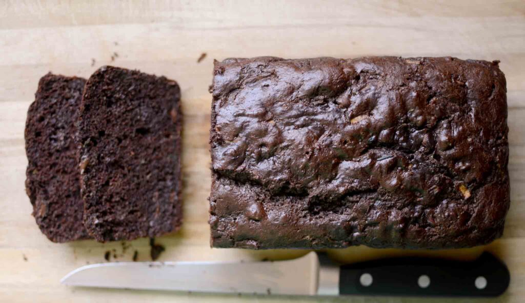 slices of sourdough chocolate zucchini bread on wood cutting board