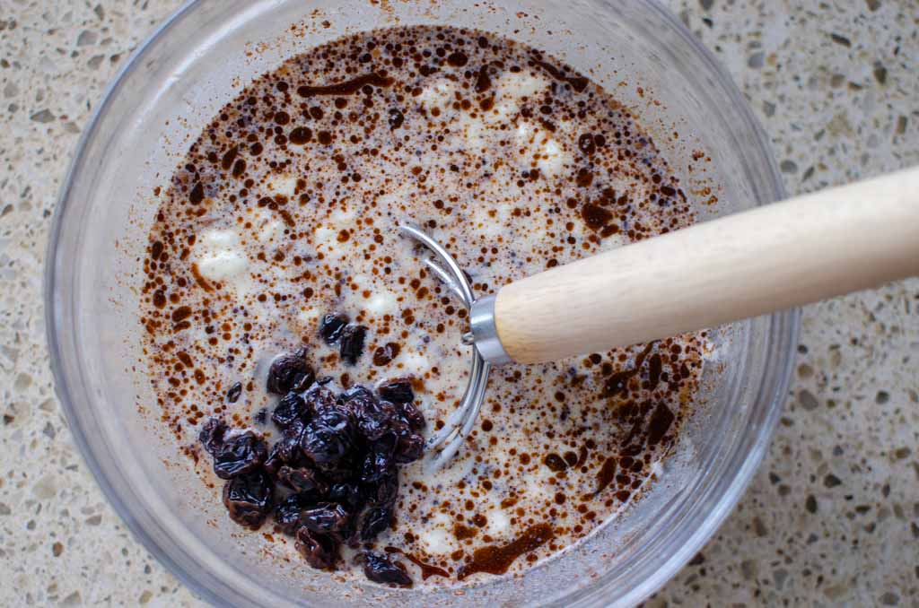 sourdough cinnamon raisin English muffin dough ingredients with dough whisk