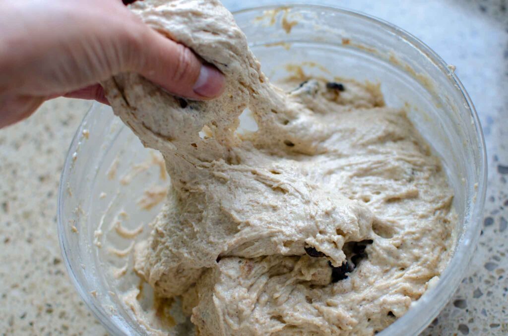 stretching the dough in a glass bowl