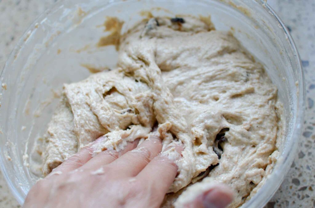 folding the dough in a bowl