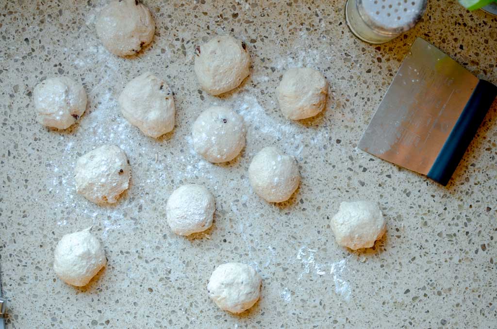 parsing out sourdough english muffin dough and rolling into balls