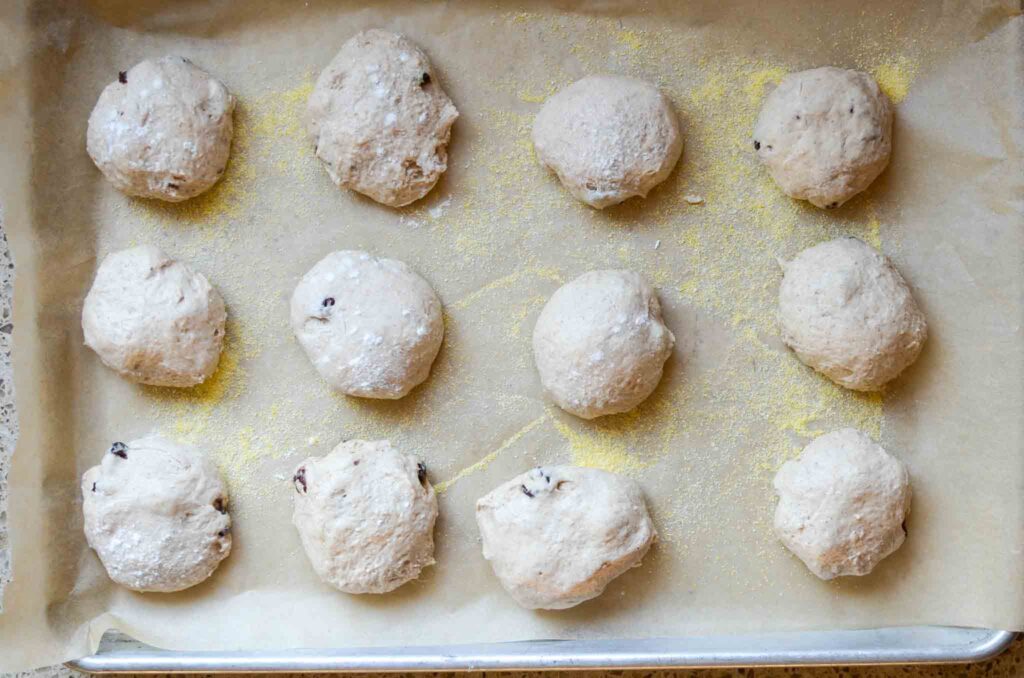 sourdough cinnamon raisin english muffins on baking sheet 