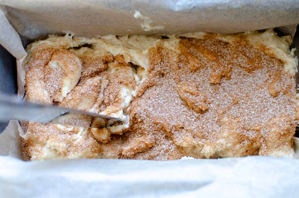 swirling the sourdough cinnamon sugar quick bread batter with a butter knife