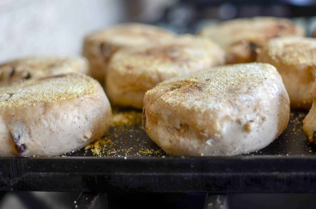 sourdough english muffins cooking on cast iron griddle 