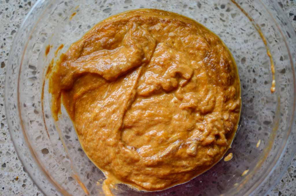 sourdough pumpkin bagel ingredients before flour is added in glass bowl