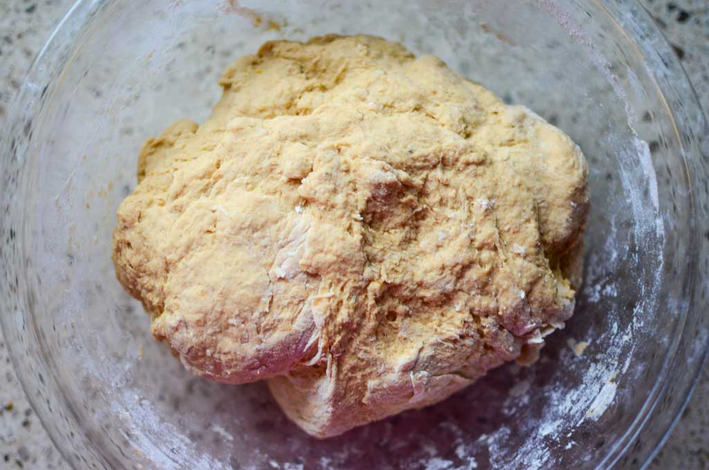 sourdough pumpkin bagel ingredients after flour is added in glass bowl