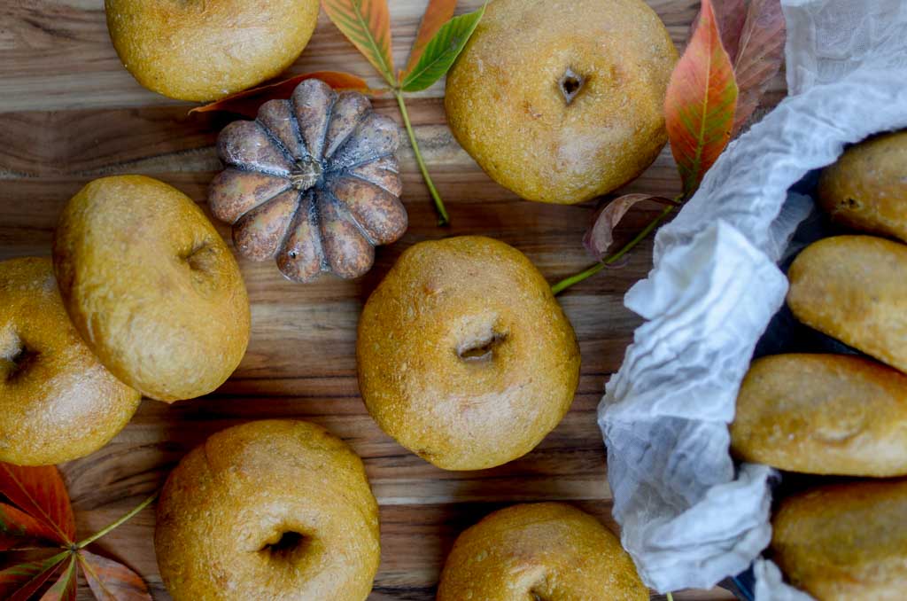 sourdough pumpkin bagels on a wooden board 