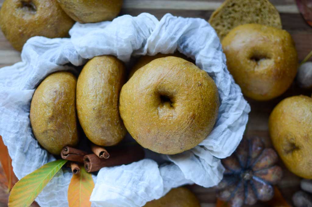 Sourdough pumpkin bagels in a cloth-lined basket