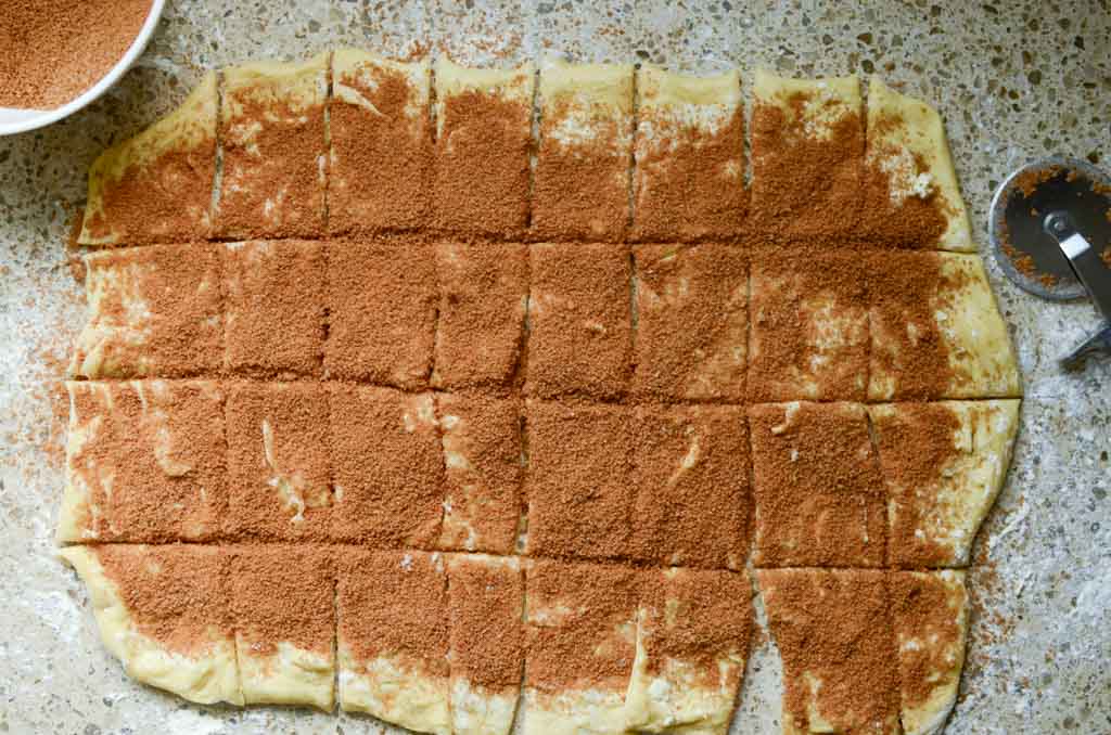 sourdough cinnamon and sugar pull-apart bread dough cut into small squares