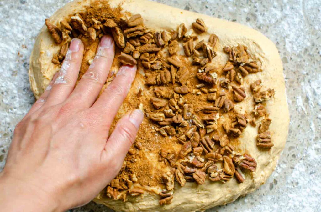 spreading pecan mixture over the dough