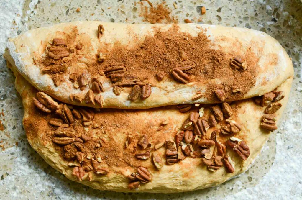 folding the dough and adding more of the pecan mixture