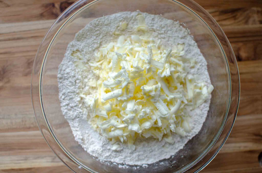 grated butter in a bowl with dry ingredients