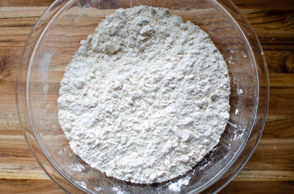 butter cut into flour mixture in glass bowl