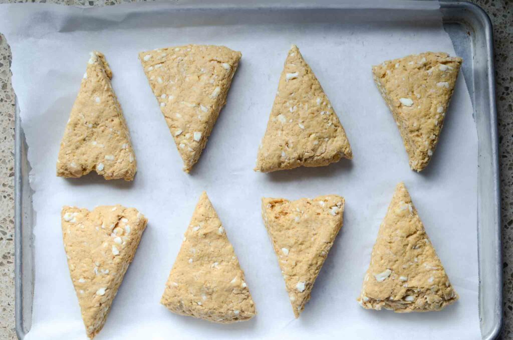 sourdough pumpkin dough wedges on a prepared baking sheet