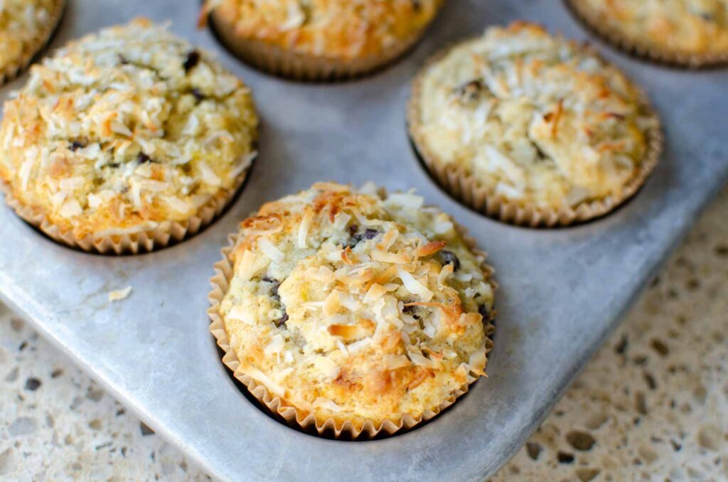 sourdough banana coconut chocolate chip muffins in a muffin tin