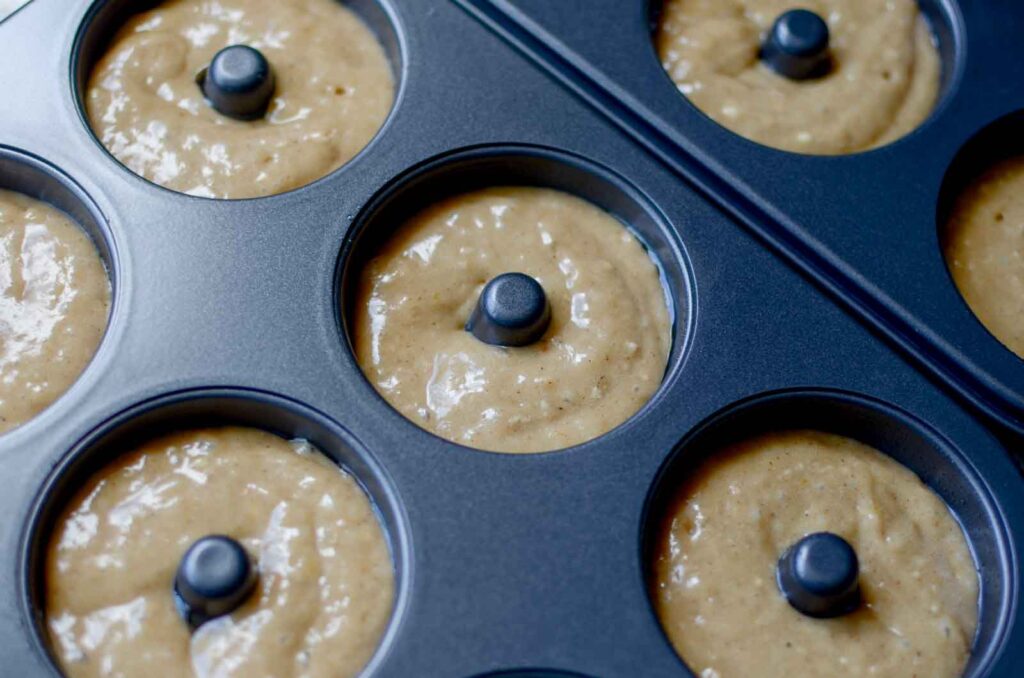 sourdough apple cider donut batter in doughnut pans