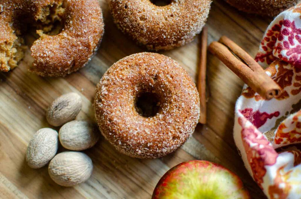 sourdough apple cider donuts on a wood cutting board 